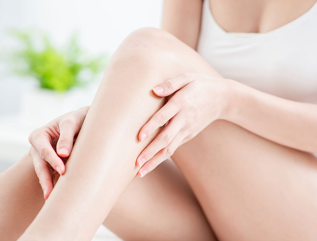 A woman feeling her hair-free leg.