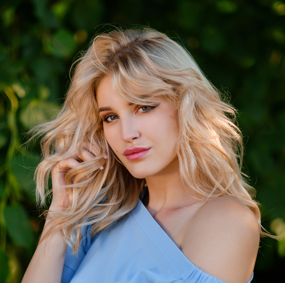 A blonde woman smiling at the camera.