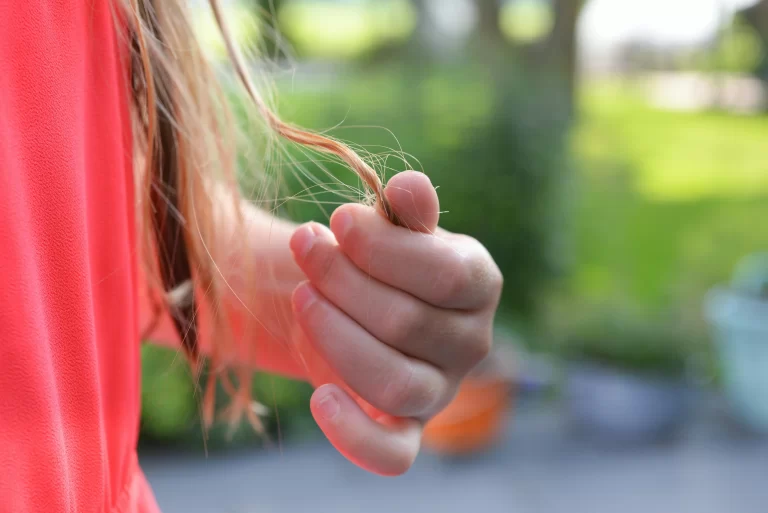 A woman touching her hair.
