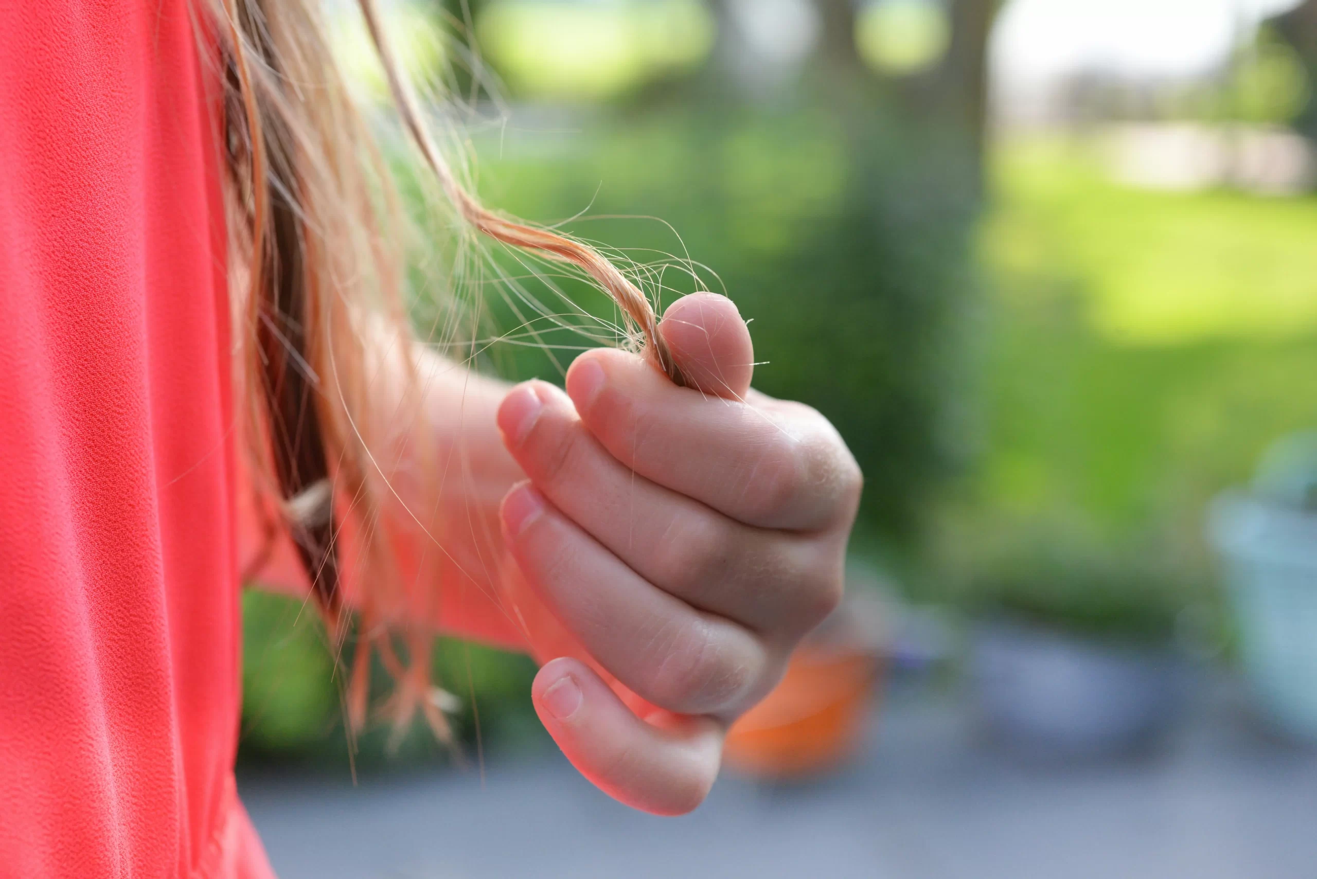A woman touching her hair.