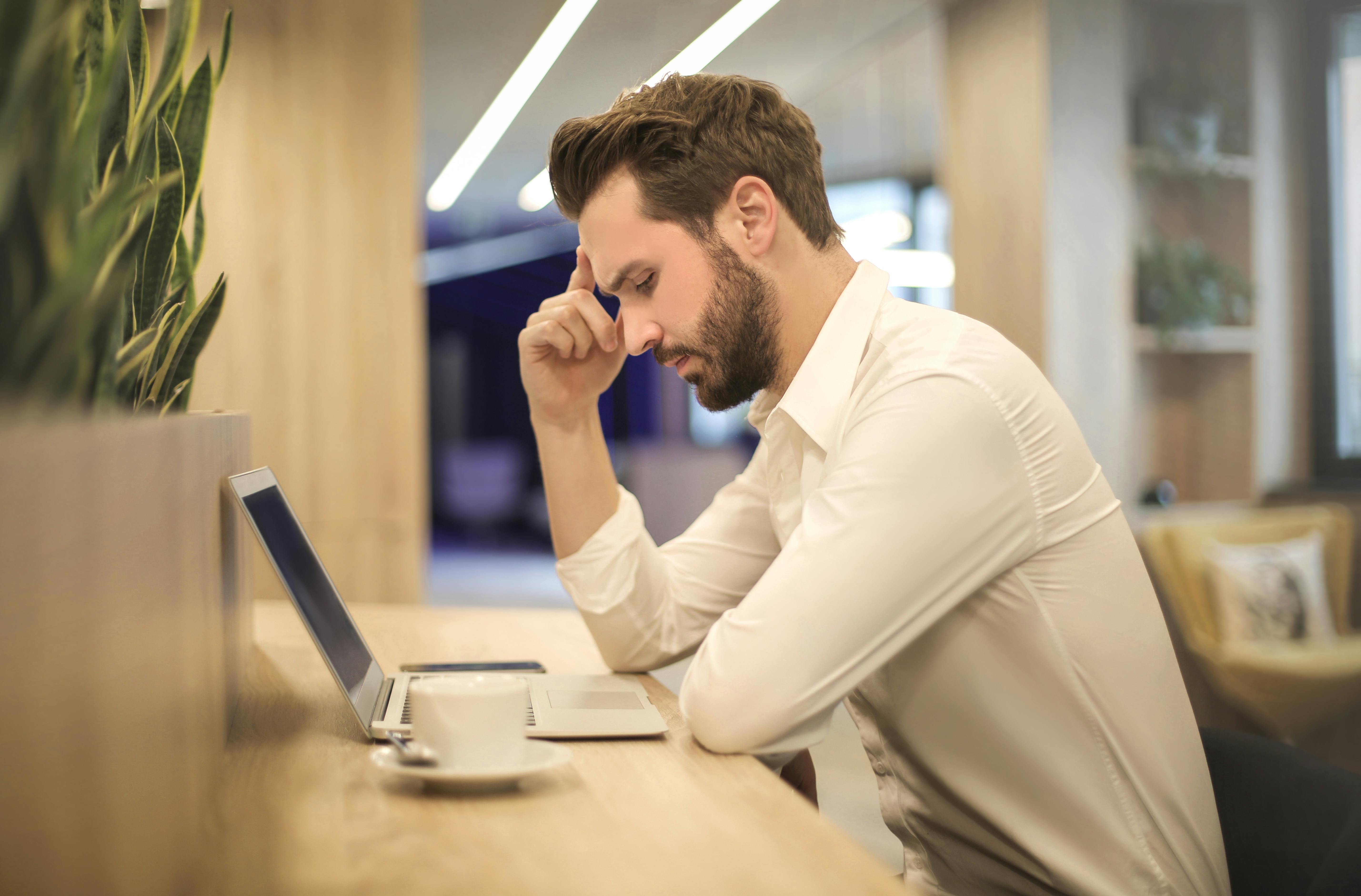 Person sitting at computer thinking