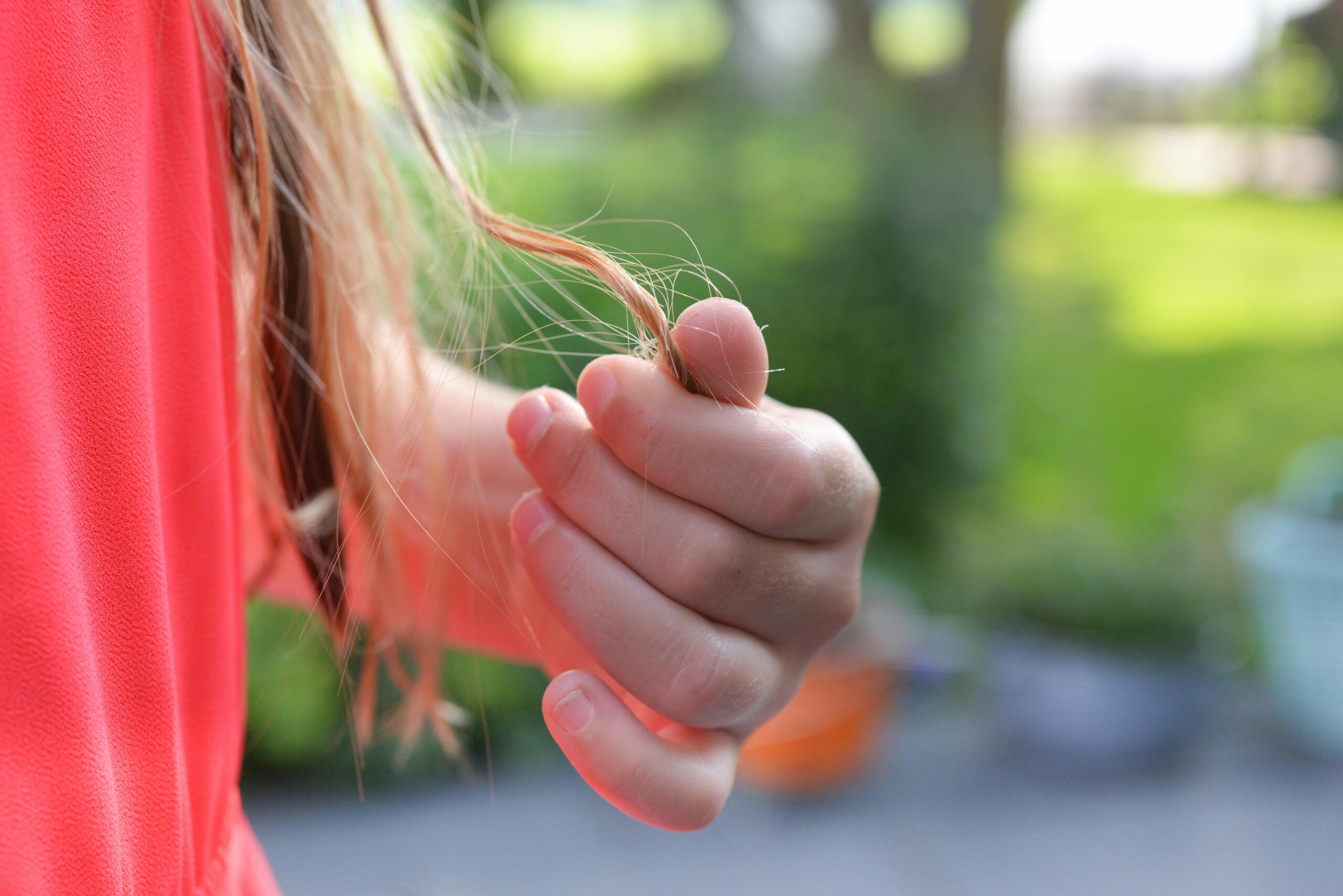 Woman holding a strand of her hair
