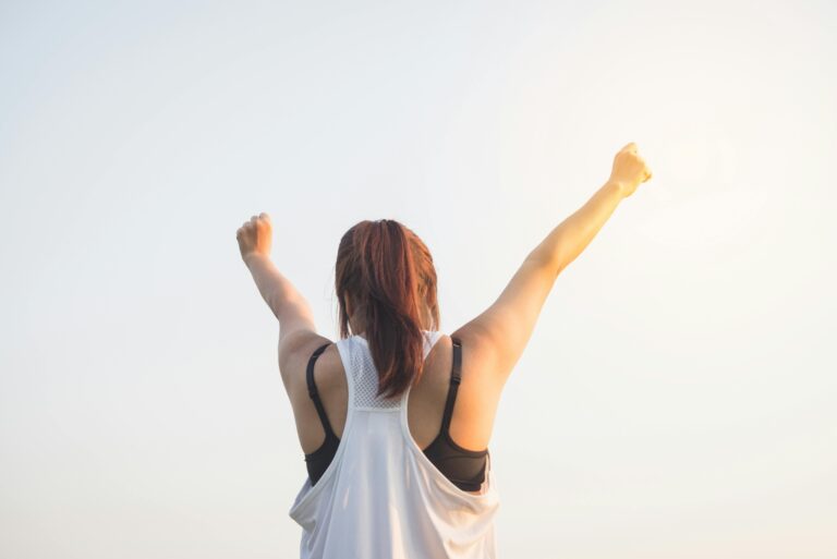 Woman stretching her arms into the air