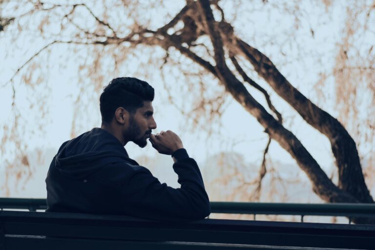 Person thinking on a park bench
