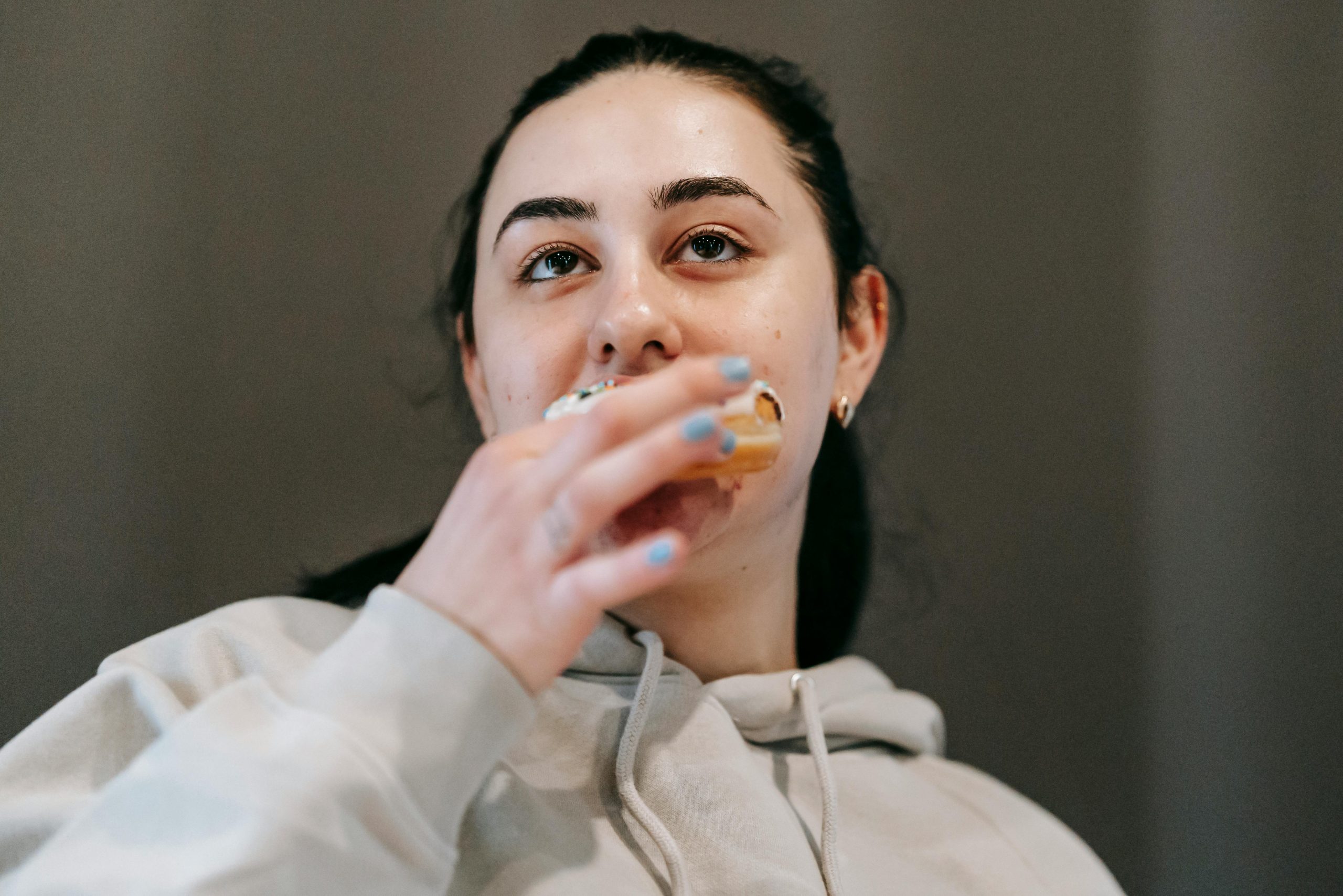 A woman eating a donut
