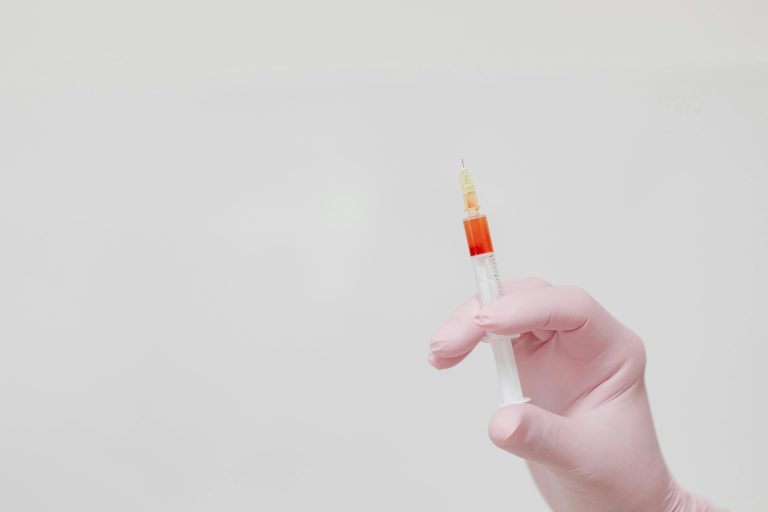 Person holding a syringe
